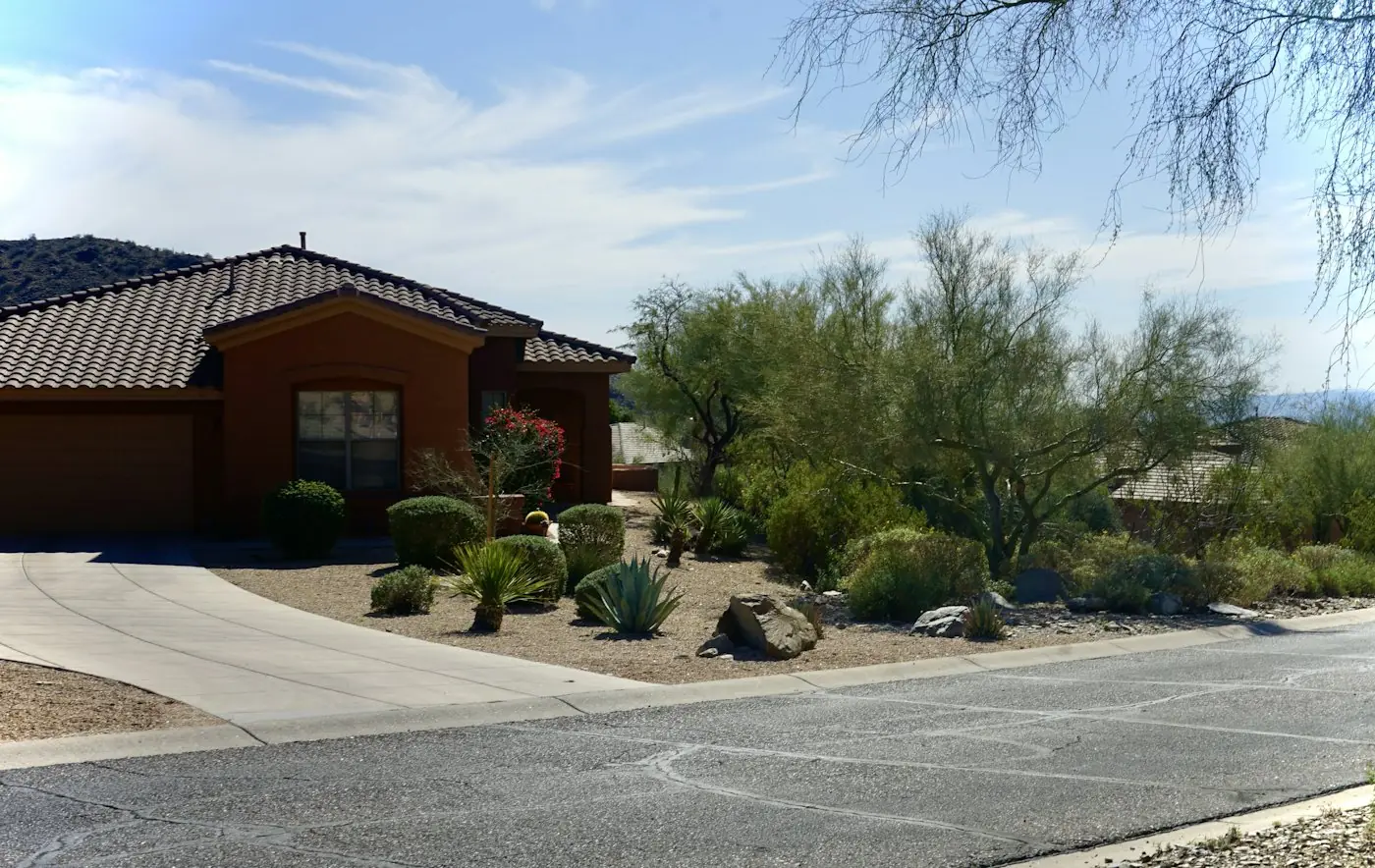 Stucco home with desert landscaping and a tile roof